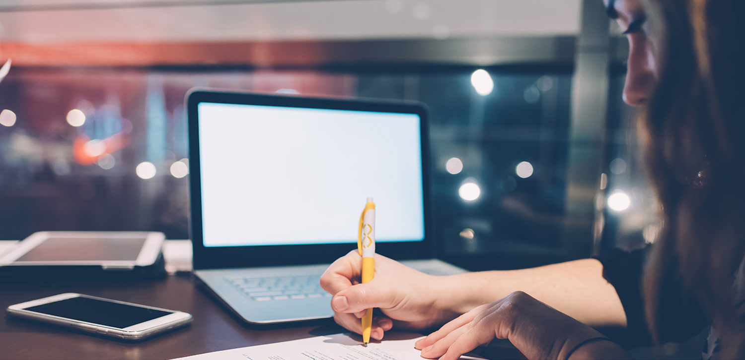 close-up-on-tha-hand-of-young-woman-writing-down-on-a-paper-using-smart-phone-and-notebook